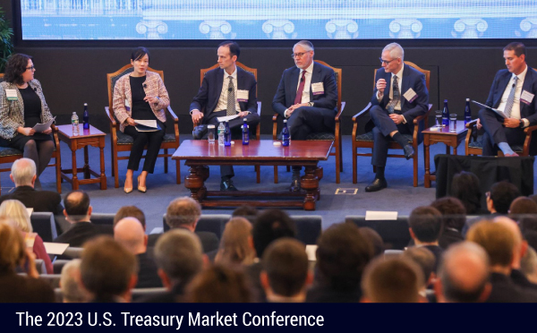 A wide shot of the moderator and five panelists on the "Assessing Recent Treasury Market Resiliency and Liquidity" panel at the 2023 U.S. Treasury Market Conference.