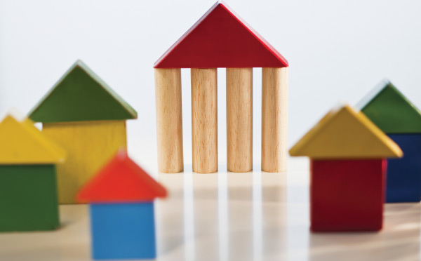 Collection of wooden blocks in red, blue, yellow, and green arranged in house shapes