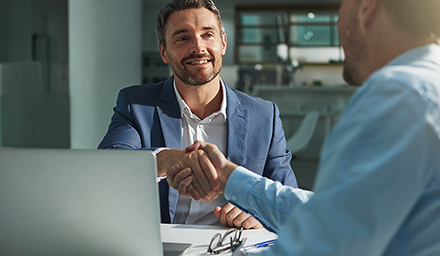 Business people, handshake and interview success or recruitment, employment and hiring in office. Corporate, men and executive shaking hands with new employee or collaboration on deal or partnership.