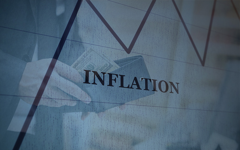 closeup of hand taking U.S. currency bills out of a wallet with an overlay of a chart line and the word inflation closeup of hand taking U.S. currency bills out of a wallet with an overlay of a chart line and the word inflation