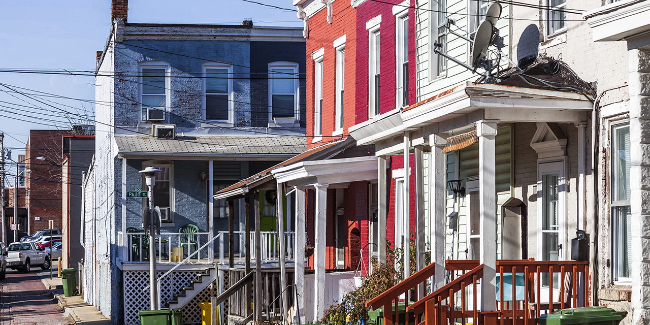 a row of colorful row houses, with bright facades, with one painted blue and the adjacent one a vibrant red a row of colorful row houses, with bright facades, with one painted blue and the adjacent one a vibrant red