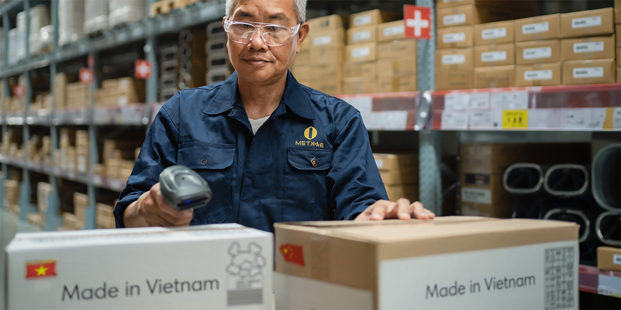 Worker wearing safety glasses and a blue uniform in a warehouse setting with shelves and packages Worker wearing safety glasses and a blue uniform in a warehouse setting with shelves and packages