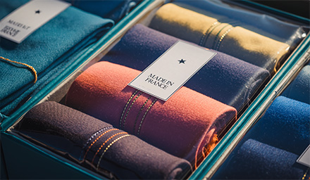 Photo: clothes rolled in a box with label on it Made in France