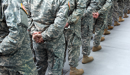 a lineup of military staff in camouflage outfits