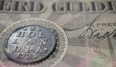 Photo: Old Dutch coins from the province of Holland with ancient Dutch banknotes.